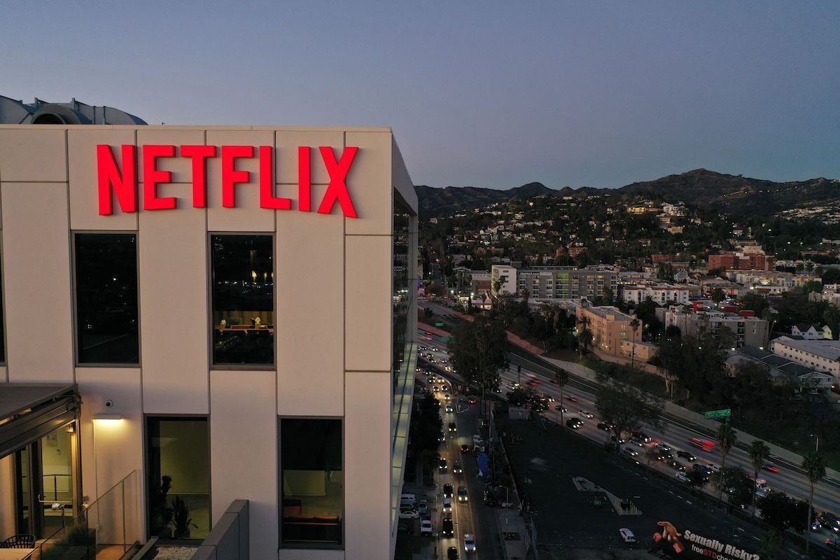 The Netflix logo on an office building amid a cityscape