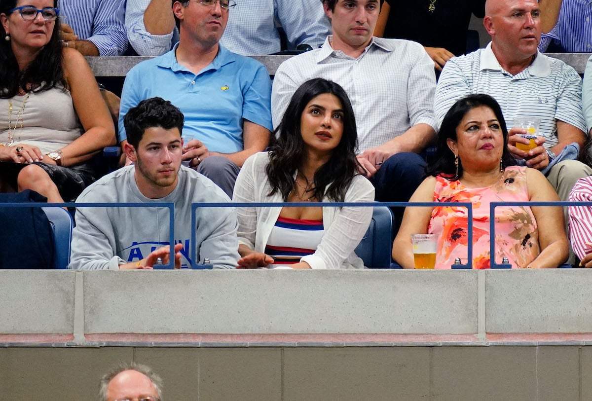 Married couple Nick Jonas and Priyanka Chopra watch the 2018 U.S. Open with Chopra's mom Madhu from their balcony seats