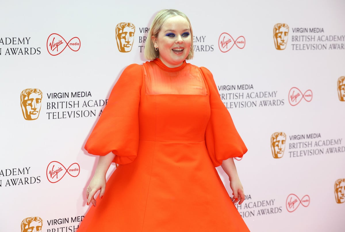 Nicola Coughlan smiling in front of a white background