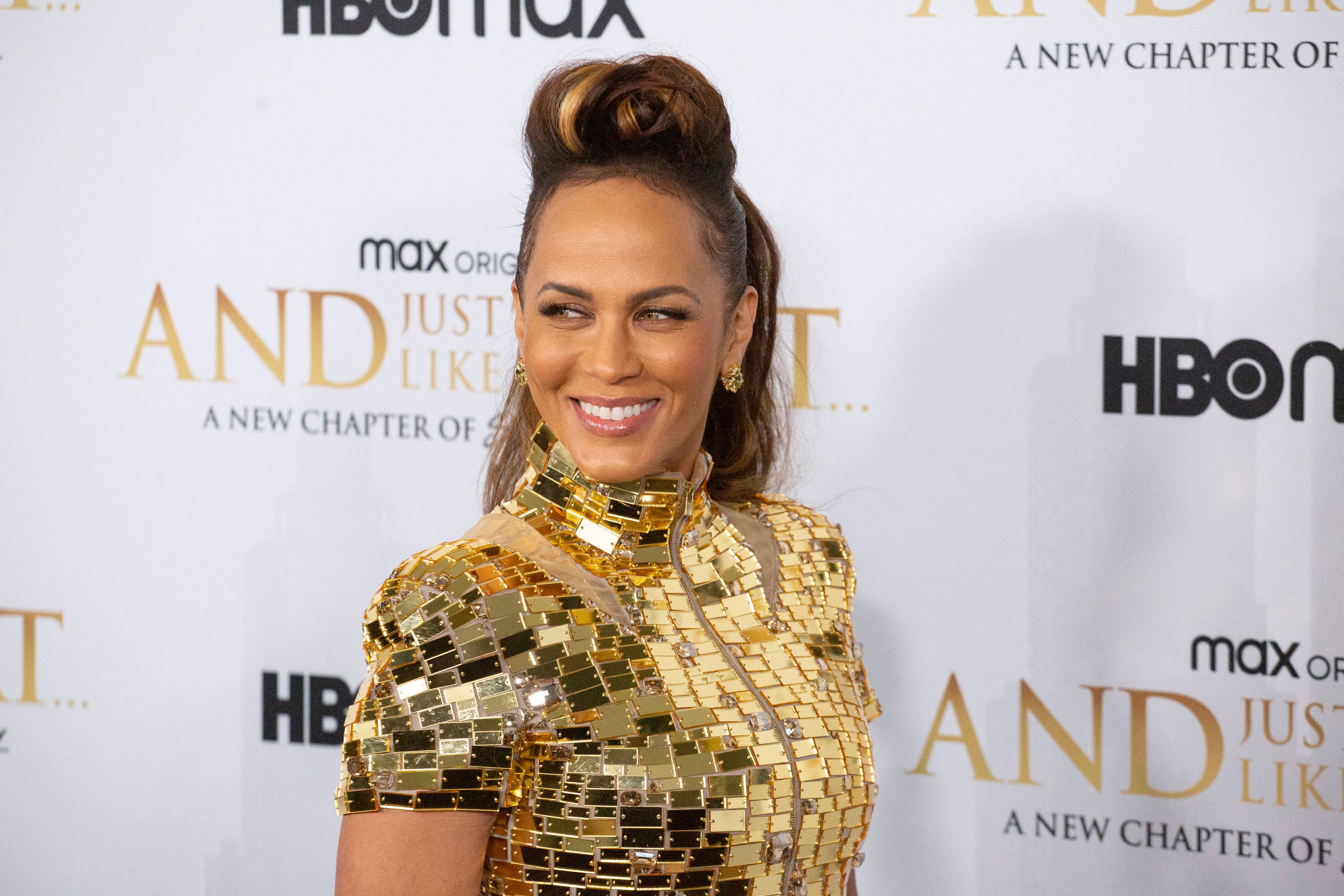 'And Just Like That...' actor Nicole Ari Parker wearing a gold dress during the show's premiere.
