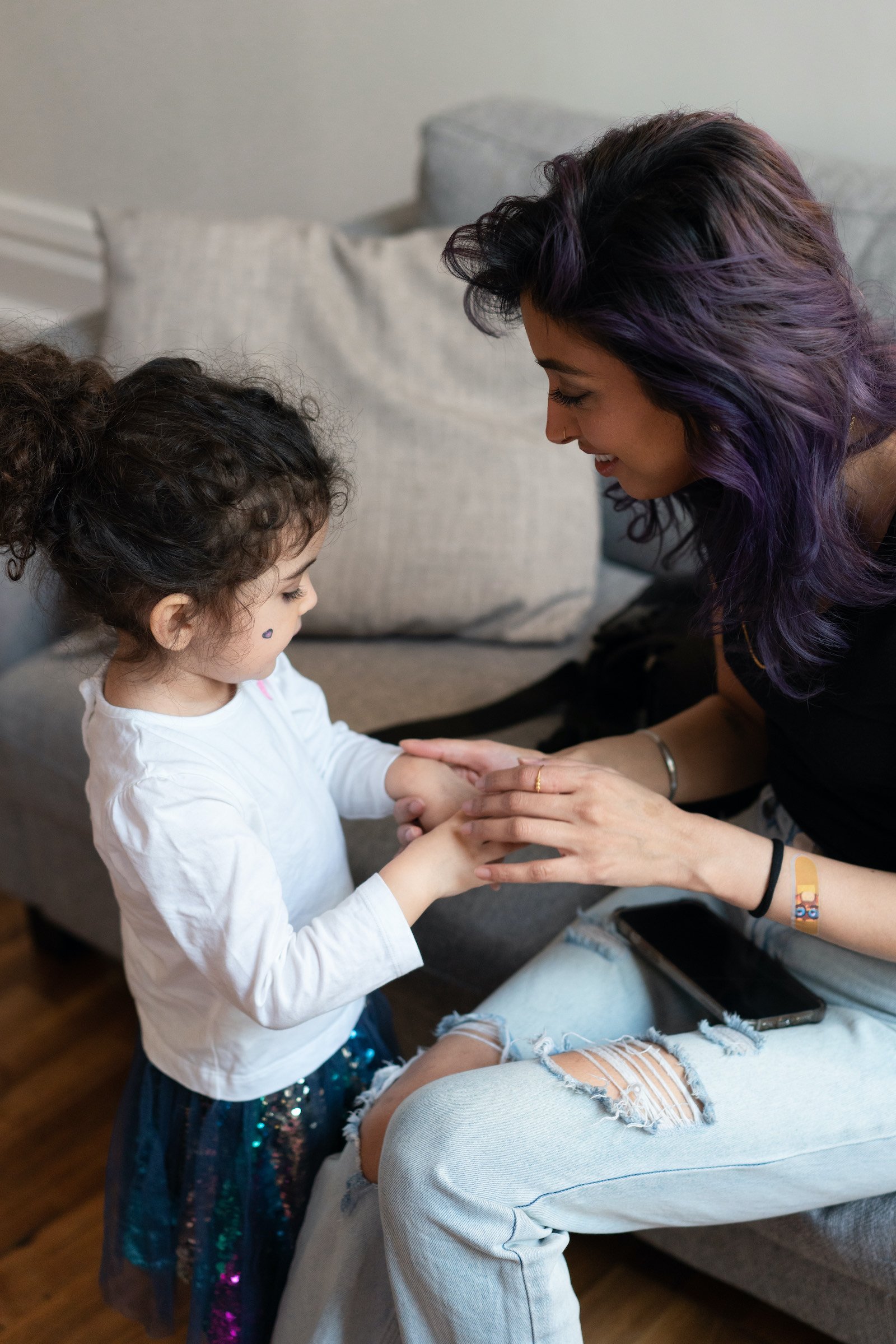 Nikita Singh hold her daughter Leela's hands