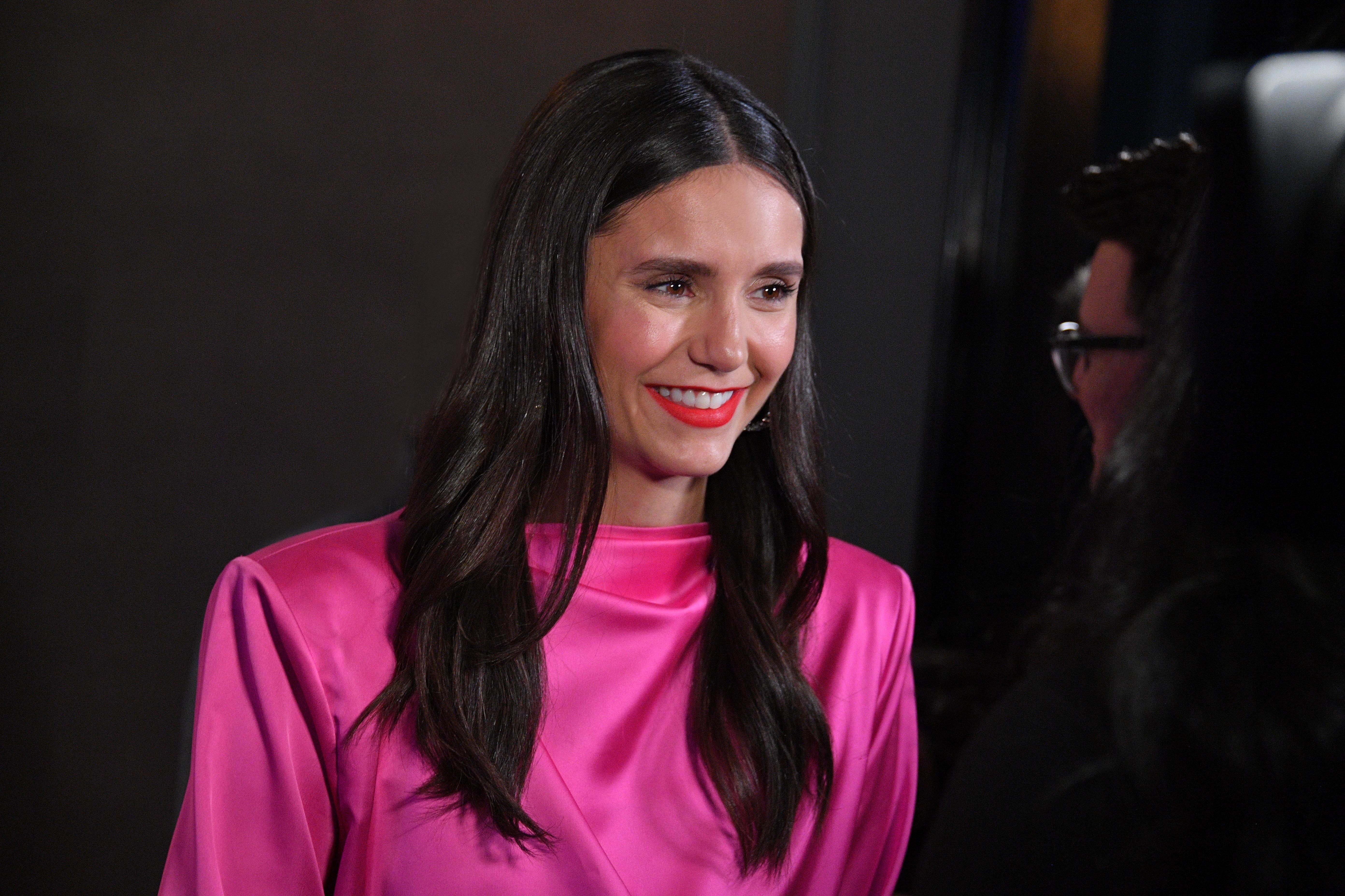 'The Vampire Diaries' star Nina Dobrev wears a bright pink dress.