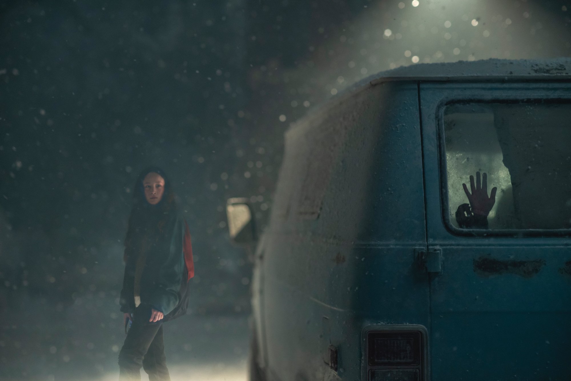 'No Exit' Havana Rose Liu as Darby walking in the snow next to a van with a hand against the glass of the back window