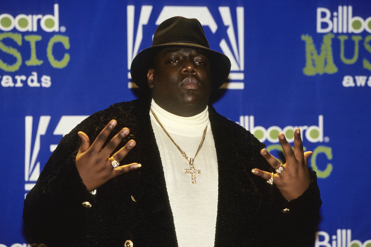 Notorious BIG in front of a blue background