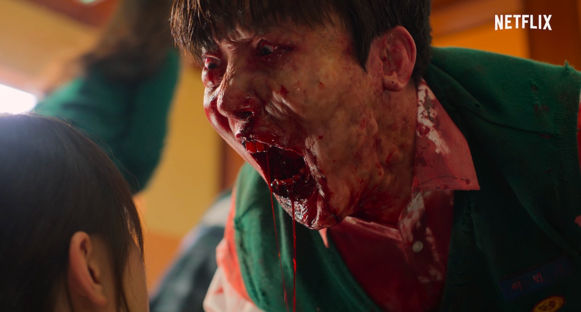 On-jo and zombie from 'All of Us Are Dead' screaming and bloody.