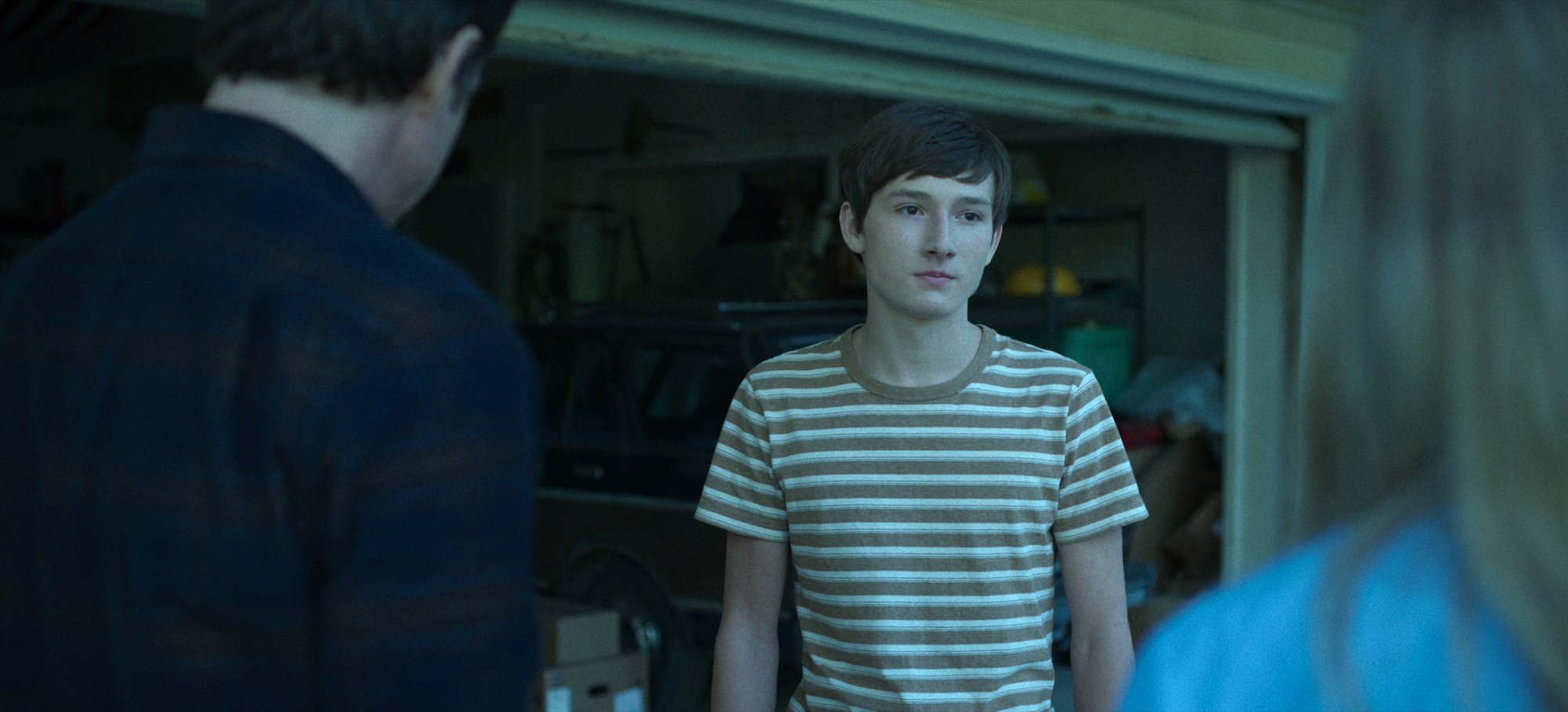 'Ozark' Season 4 star Skyler Gaertner as Jonah Byrde wearing a striped shirt in a production still from the series.
