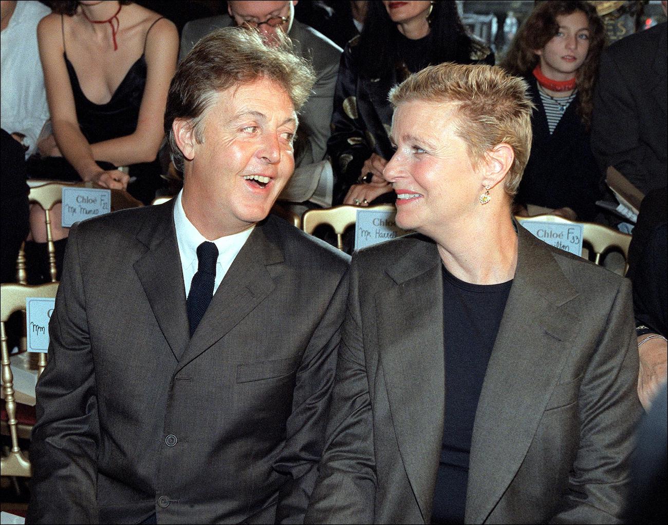 Paul McCartney and his wife Linda McCartney wearing suits at their daughter, Stella's fashion show in 1998.