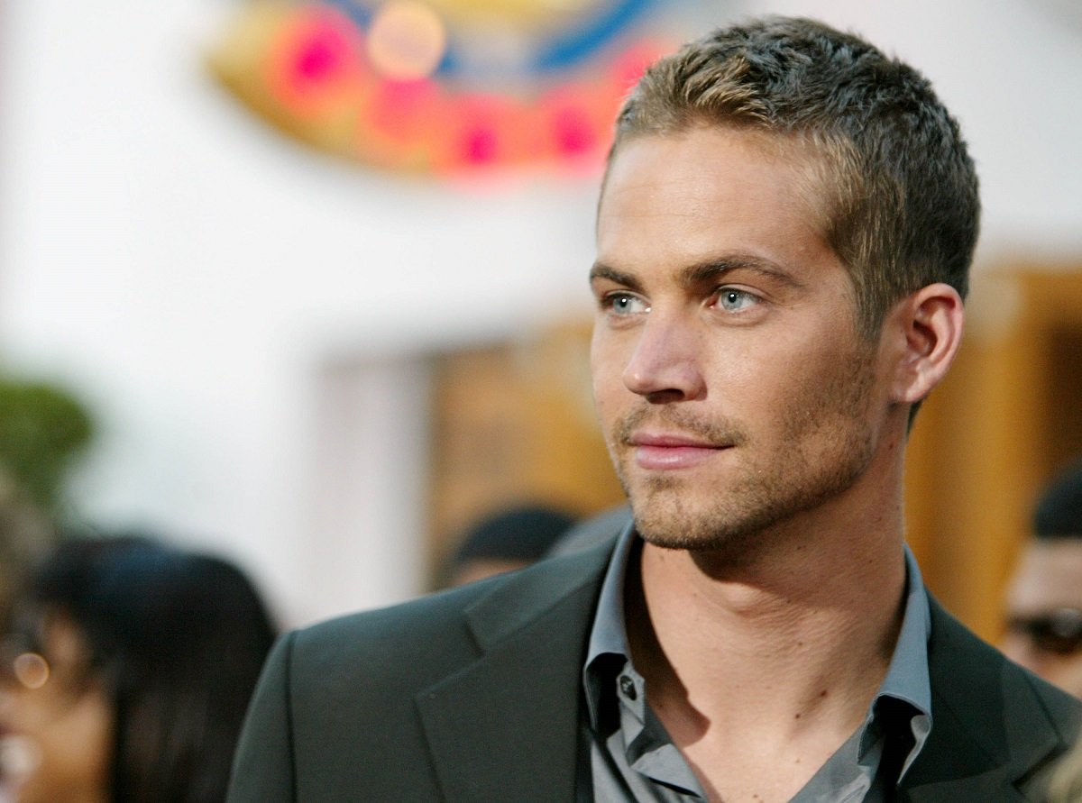 Paul Walker posing while wearing a suit.