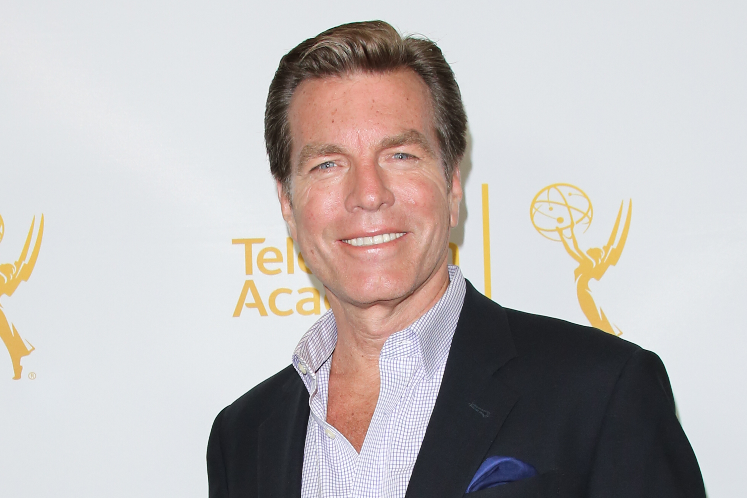 'The Young and the Restless' actor Peter Bergman wearing a blue suit and shirt during a red carpet appearance.