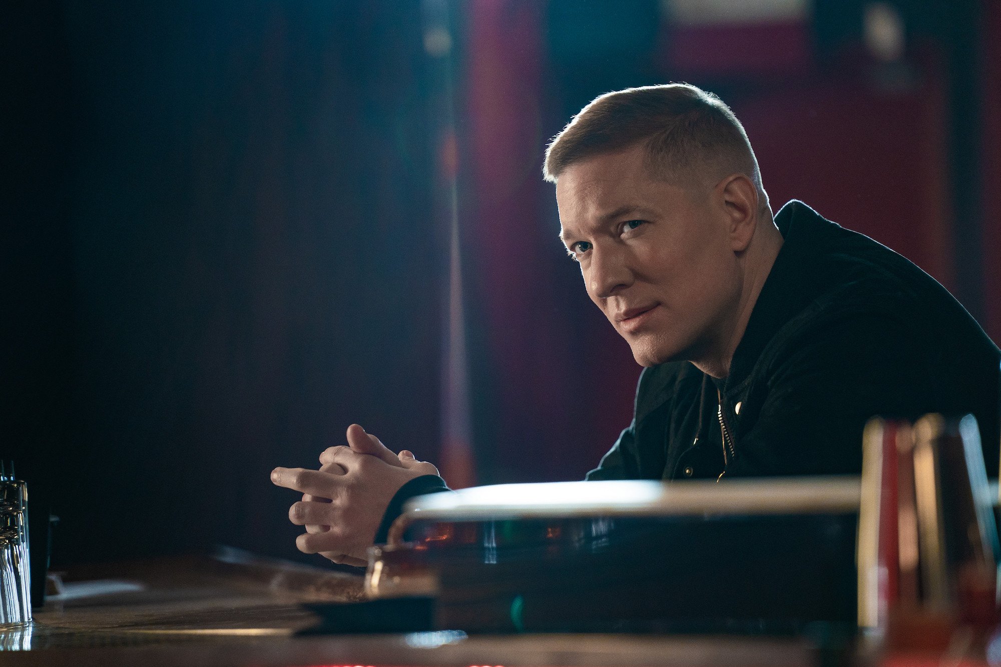 'Power: Book IV: Force' star Joseph Sikora sits at a desk with his hands folded