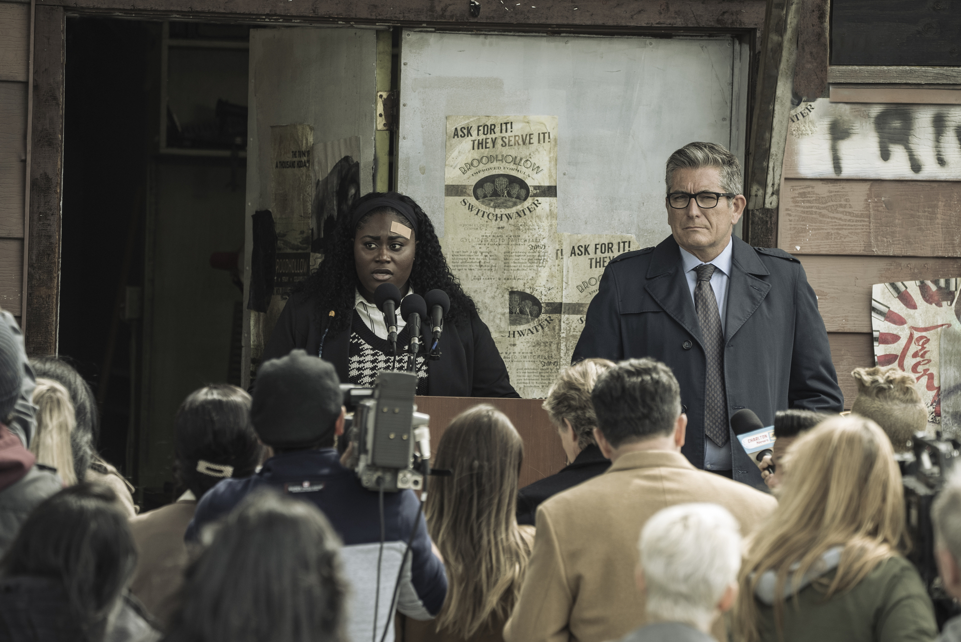 Danielle Brooks as Leota Adebayo in 'Peacemaker' Episode 8. She's holding a press conference, speaking before a crowd.