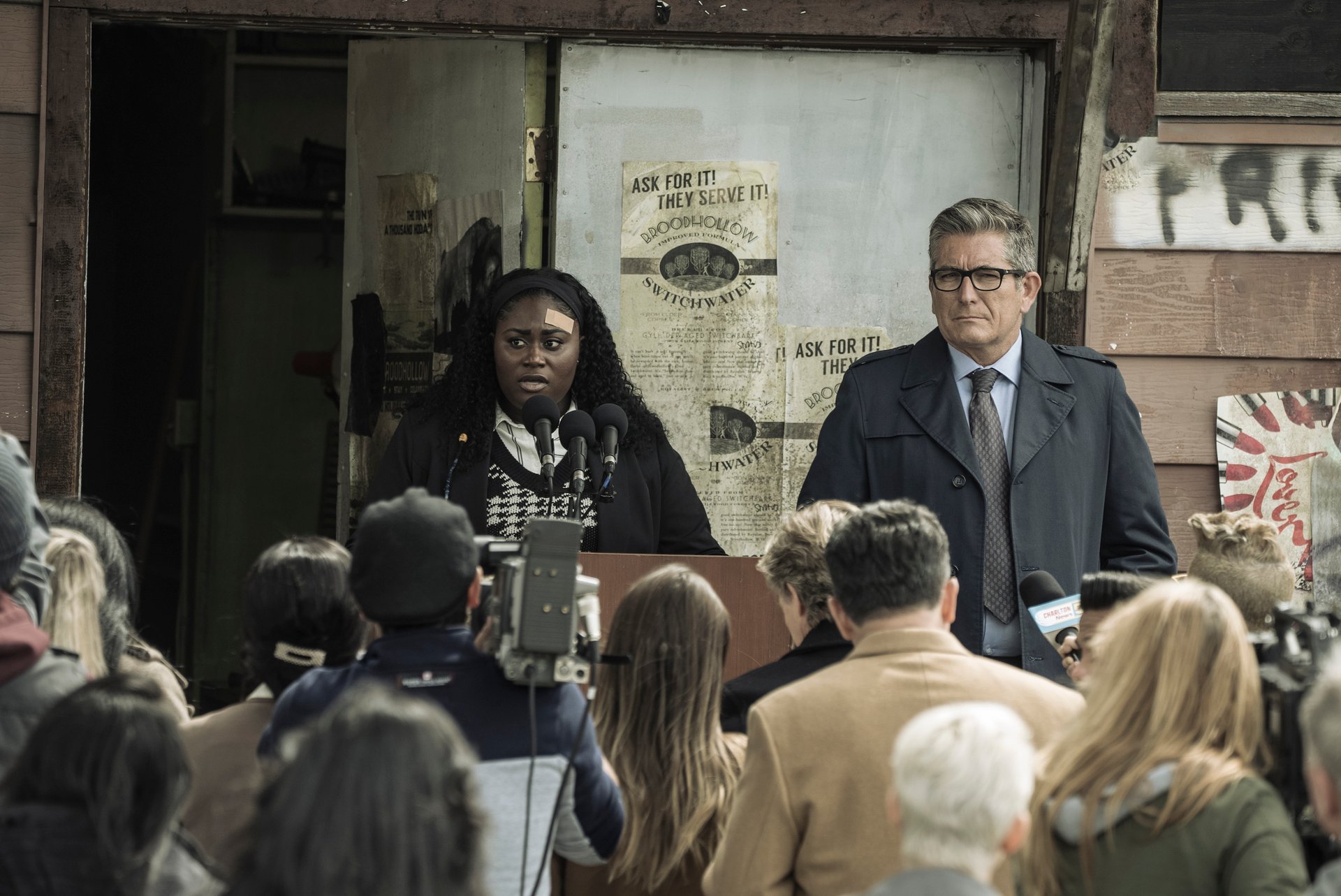 Danielle Brooks as Leota Adebayo in 'Peacemaker' Episode 8. She's holding a press conference, speaking before a crowd.