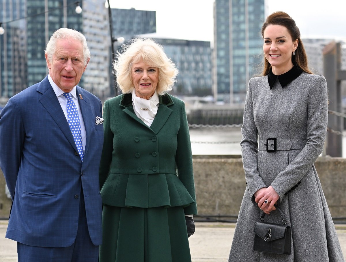 Prince Charles, Camilla Parker Bowles, and Kate Middleton pose for a photo together during their visit to The Prince's Foundation training site