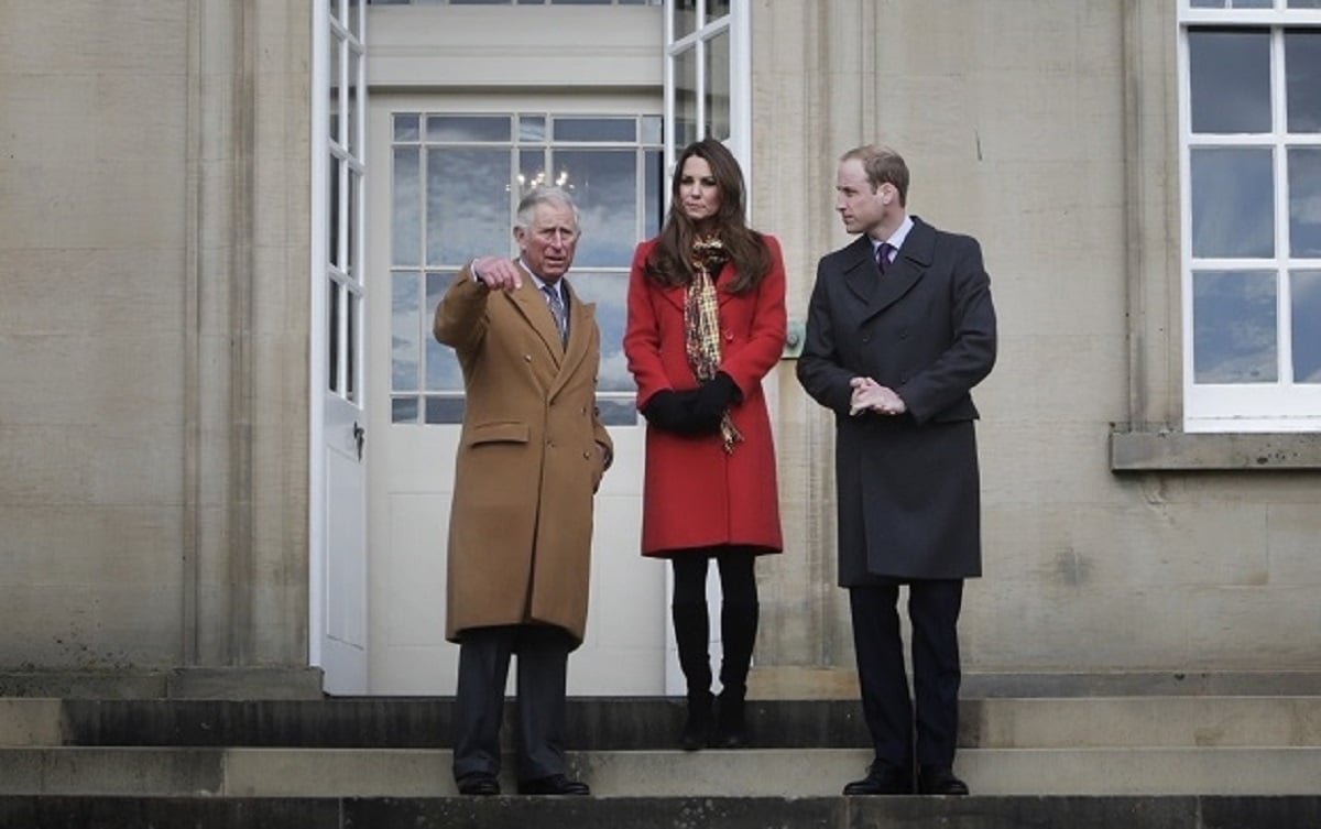 Prince Charles, Kate Middleton, and Prince William standing together in front of Dumfries House in Scotland