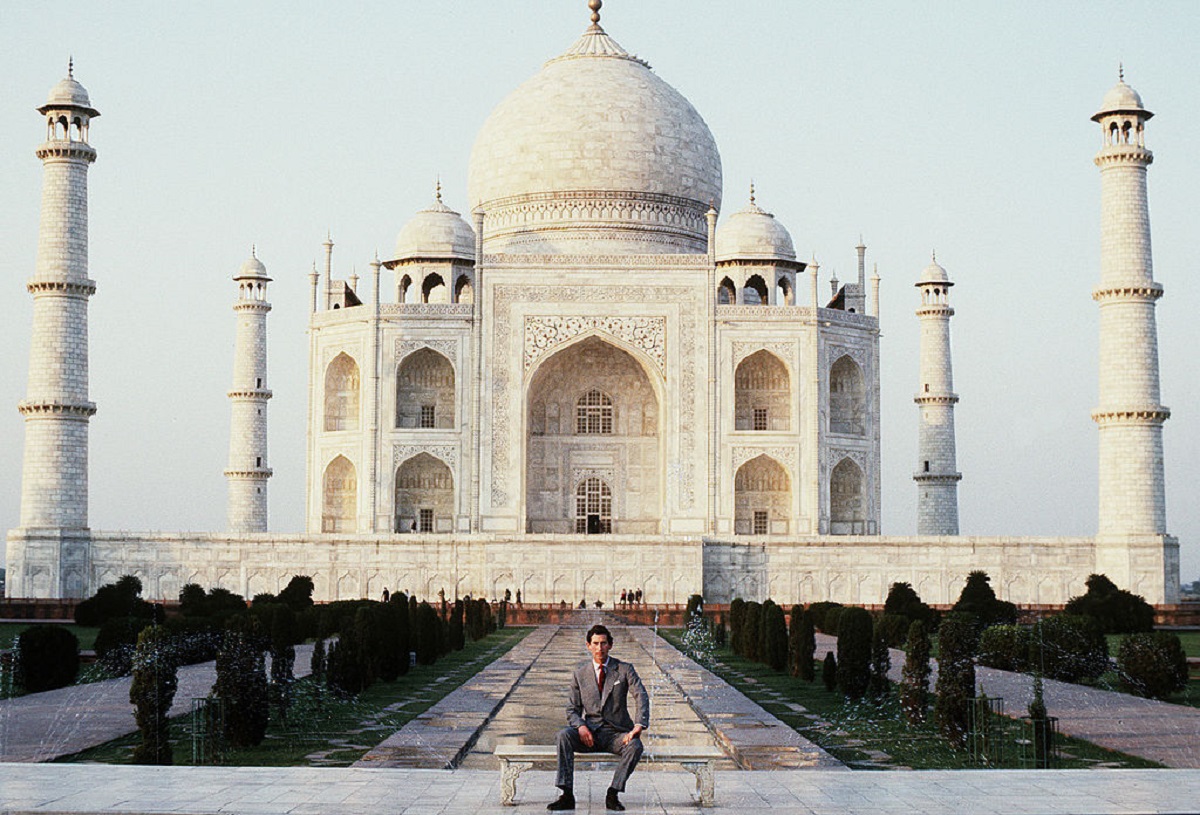 Prince Charles sitting by himself at the Taj Mahal