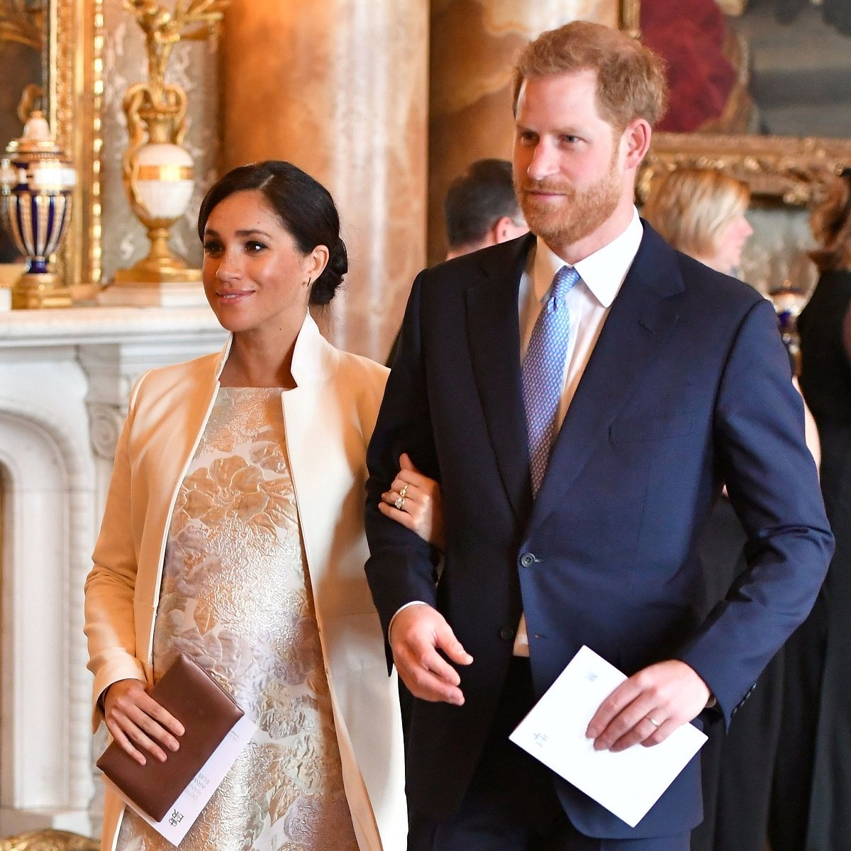 Prince Harry and Meghan Markle walking arm in arm to reception at Buckingham Palace