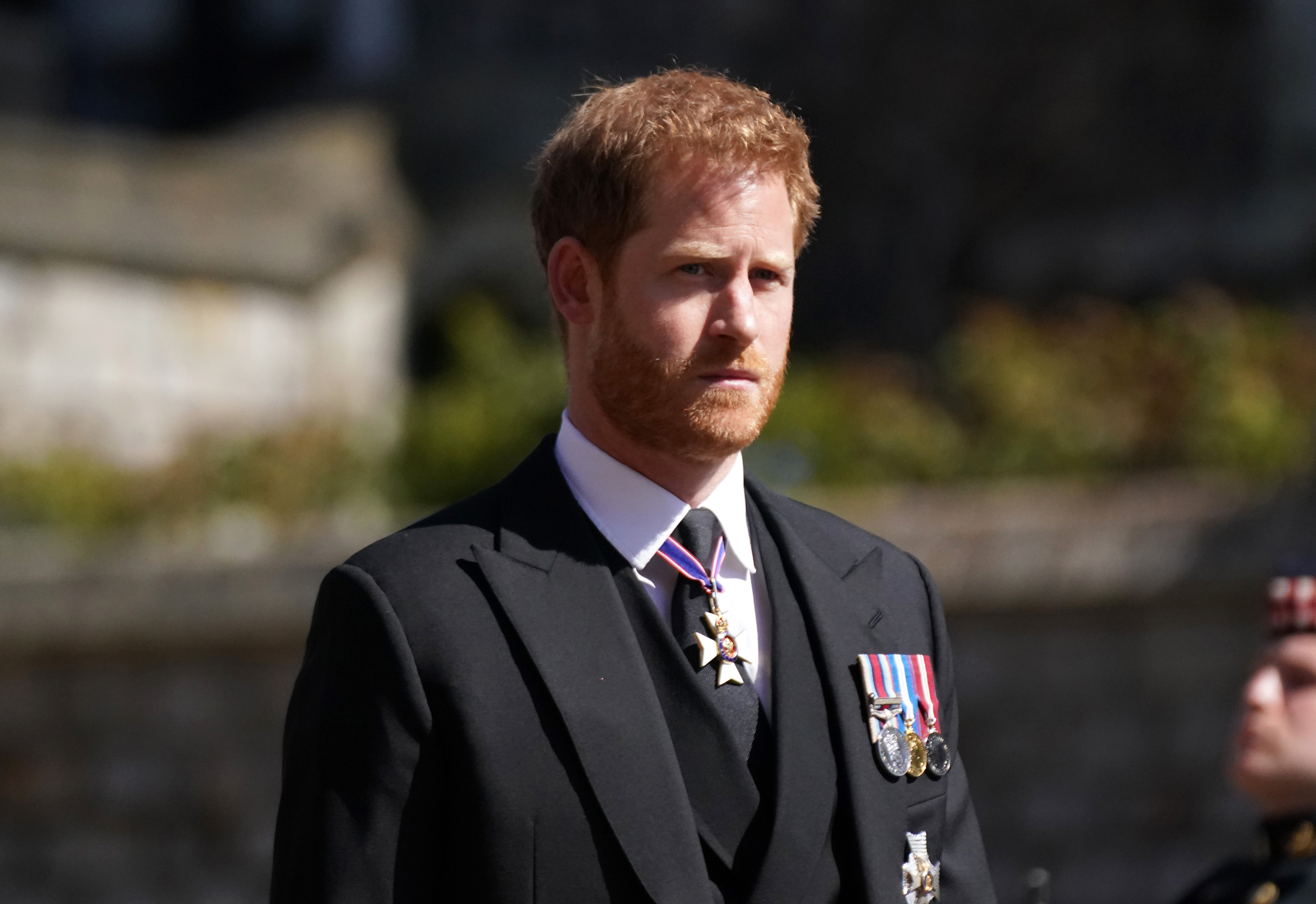 Prince Harry standing outside of St. George's Chapel for Prince Philip's funeral