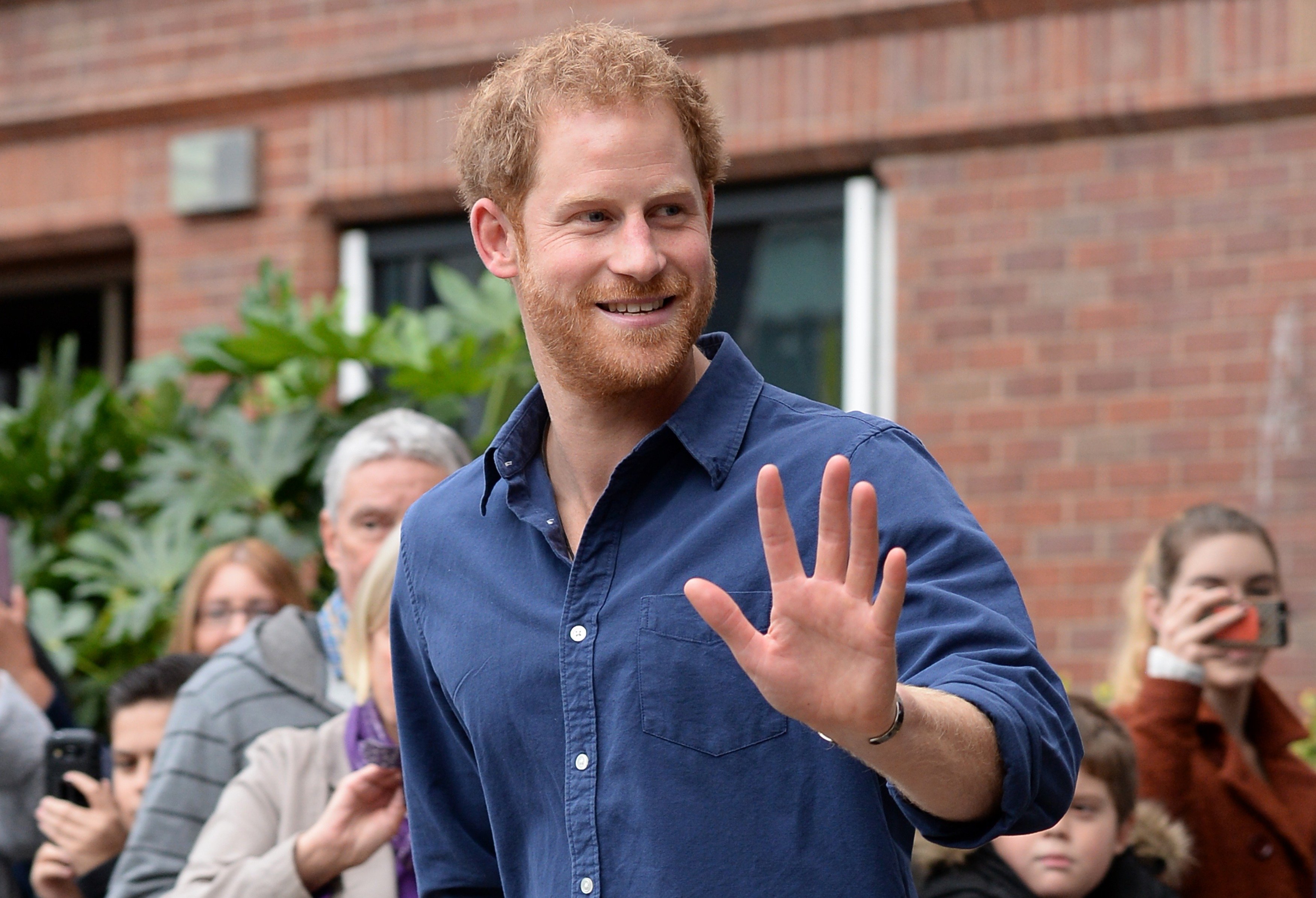 Prince Harry waves to crowd as he leaves Nottingham's Central Police Station