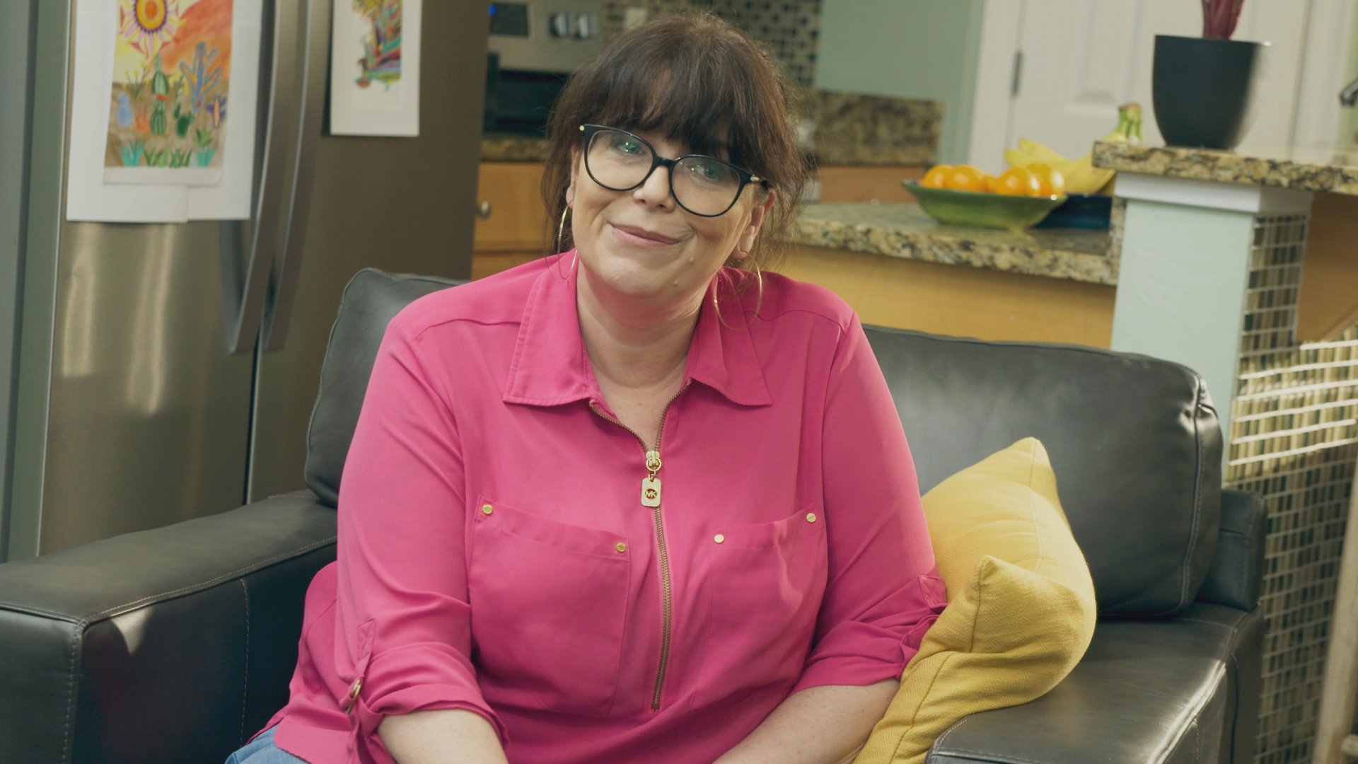 Chelsea Holmes, in a pink shirt, in an episode of 'Prisoner of Love'