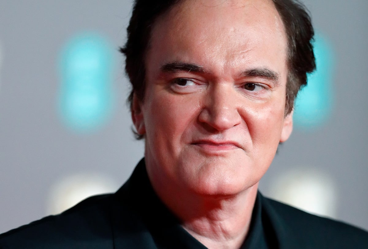 Quentin Tarantino looking over to the side.