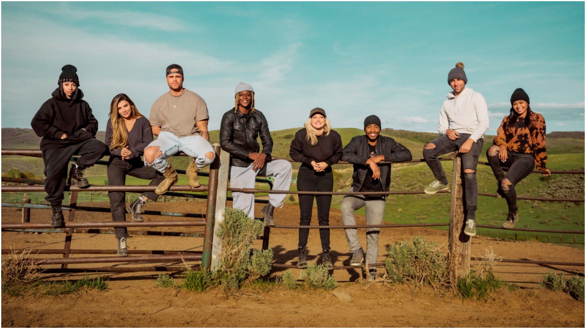 The cast of Relatively Famous: Ranch Rules hangs out around a ranch fence for a photo 