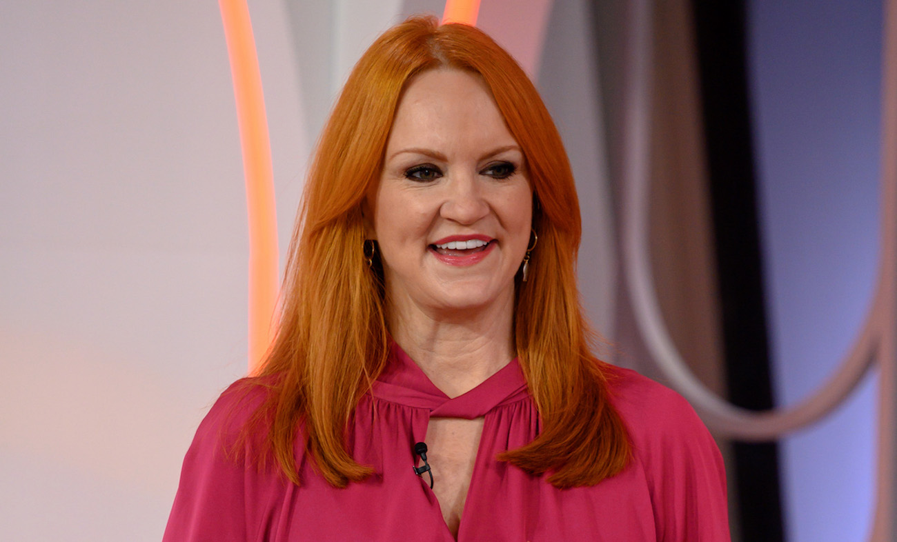 Ree Drummond looks on wearing a bright pink shirt