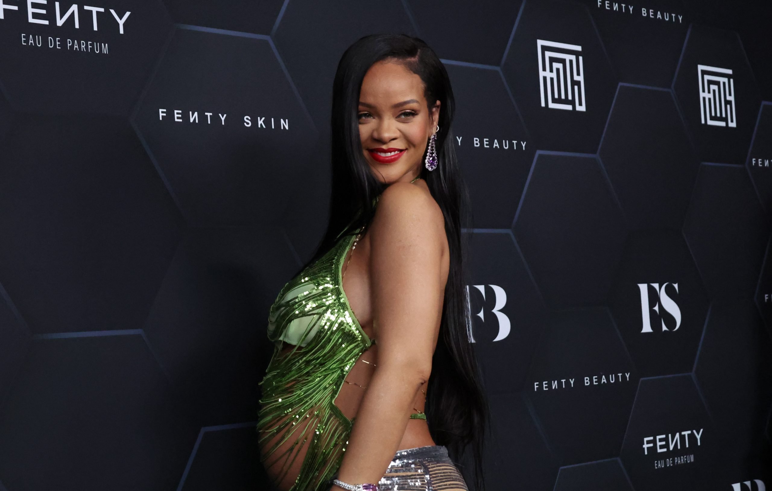 Rihanna wearing a green sequin tanktop
