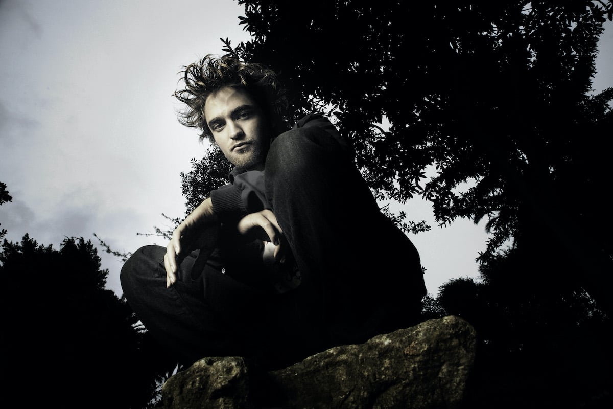 Twilight star Robert Pattinson (Edward Cullen) squats for cast photos