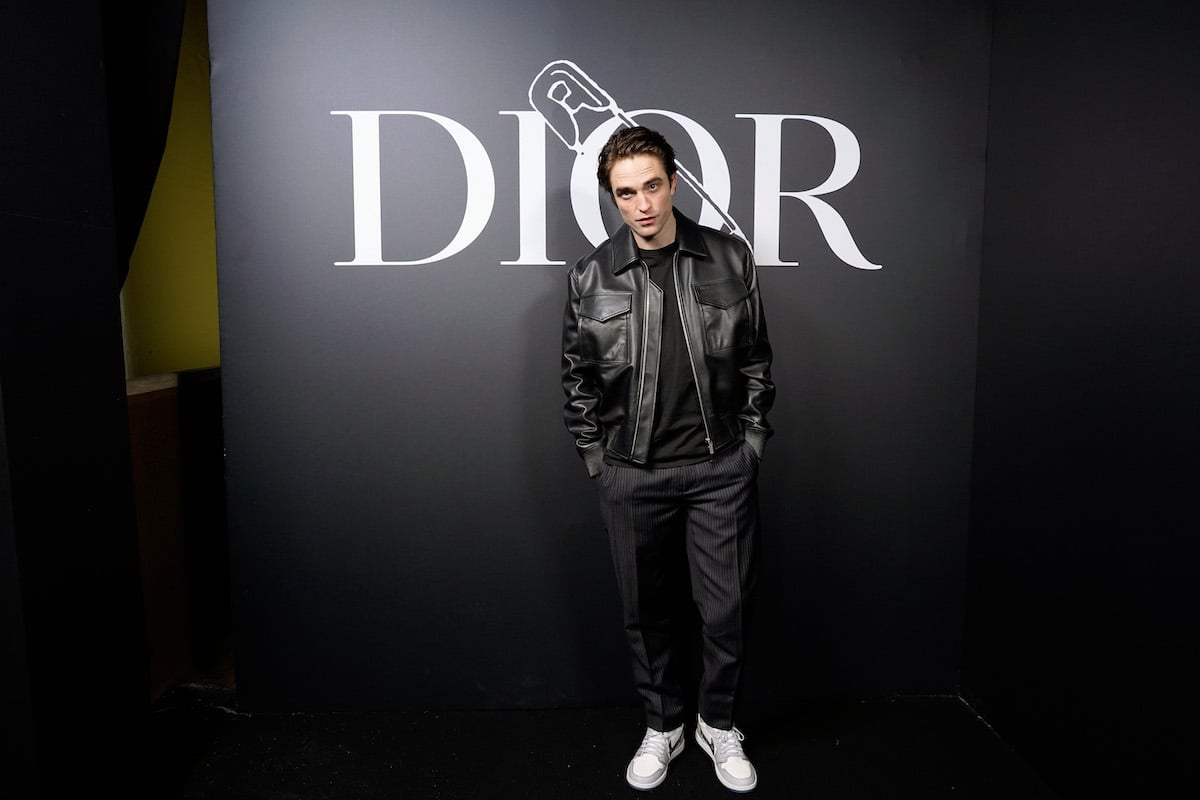 British actor Robert Pattinson poses in front of the Dior sign at the Dior Homme Menswear Fall/Winter 2020-21 show