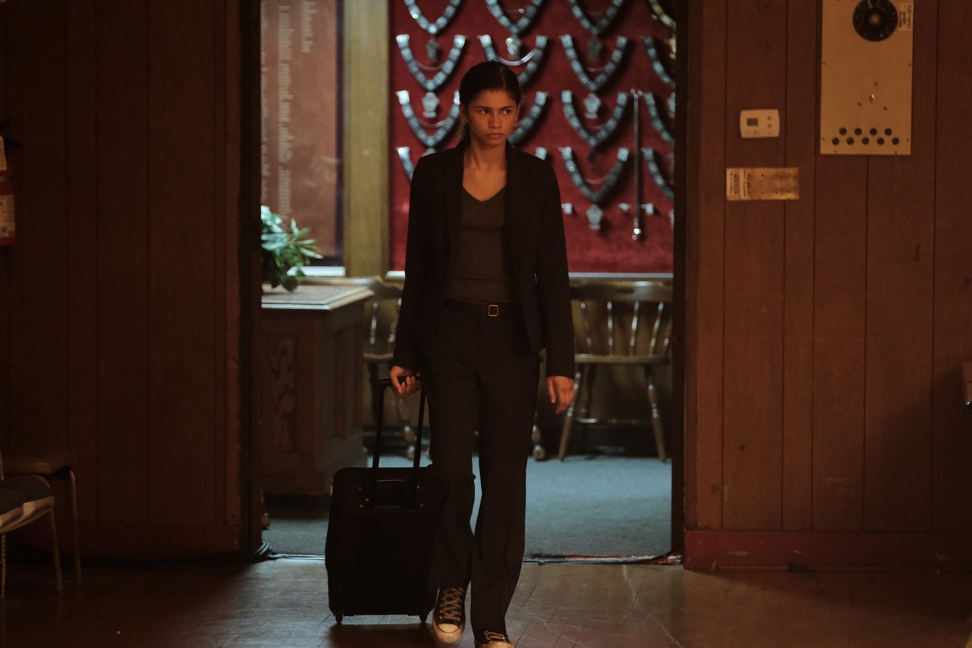 Rue holding a suitcase while walking through a house in 'Euphoria' Season 2