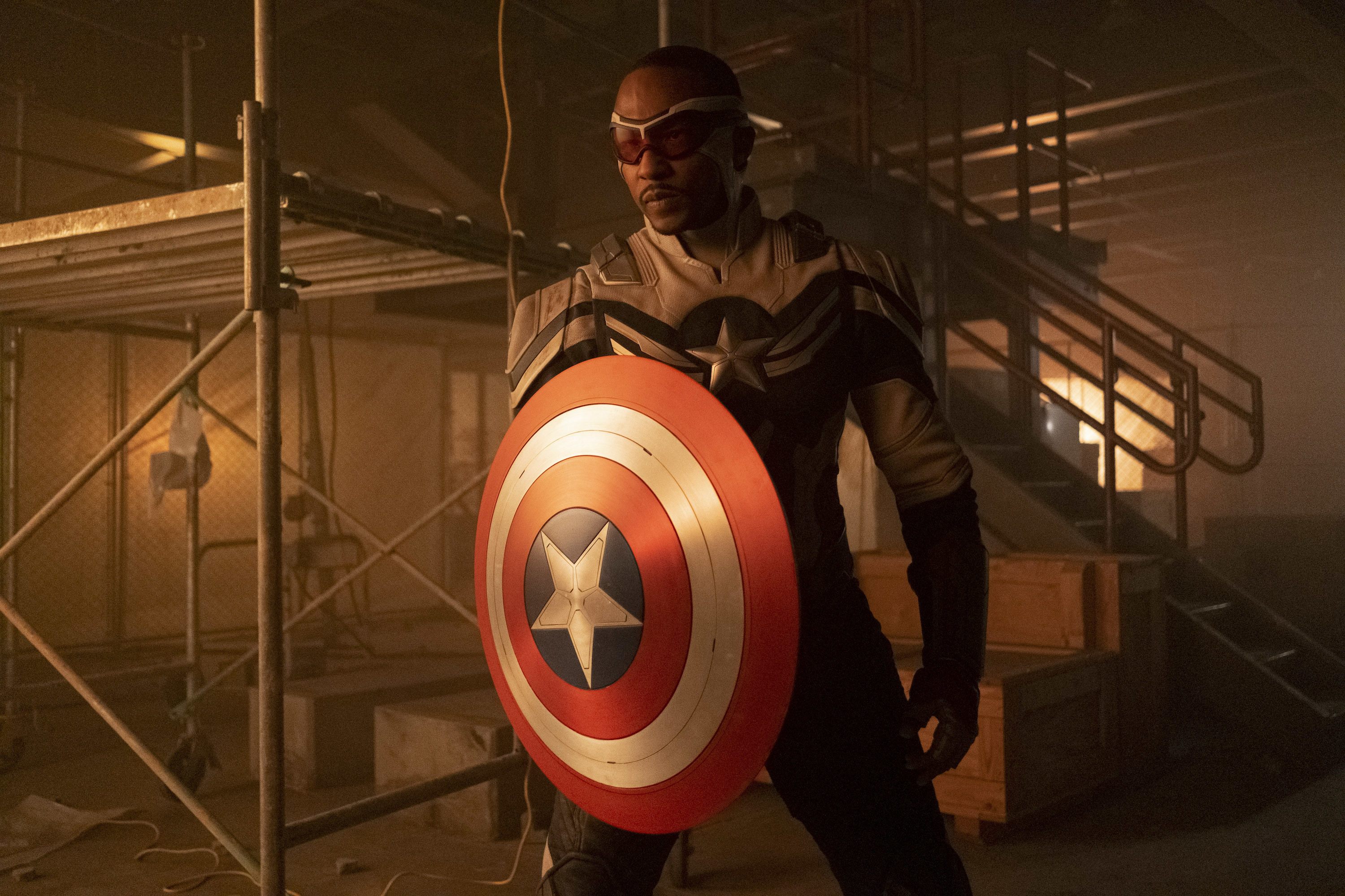 Anthony Mackie as Sam Wilson in 'The Falcon and the Winter Soldier.' He's dressed in his Captain America suit and holding the shield.
