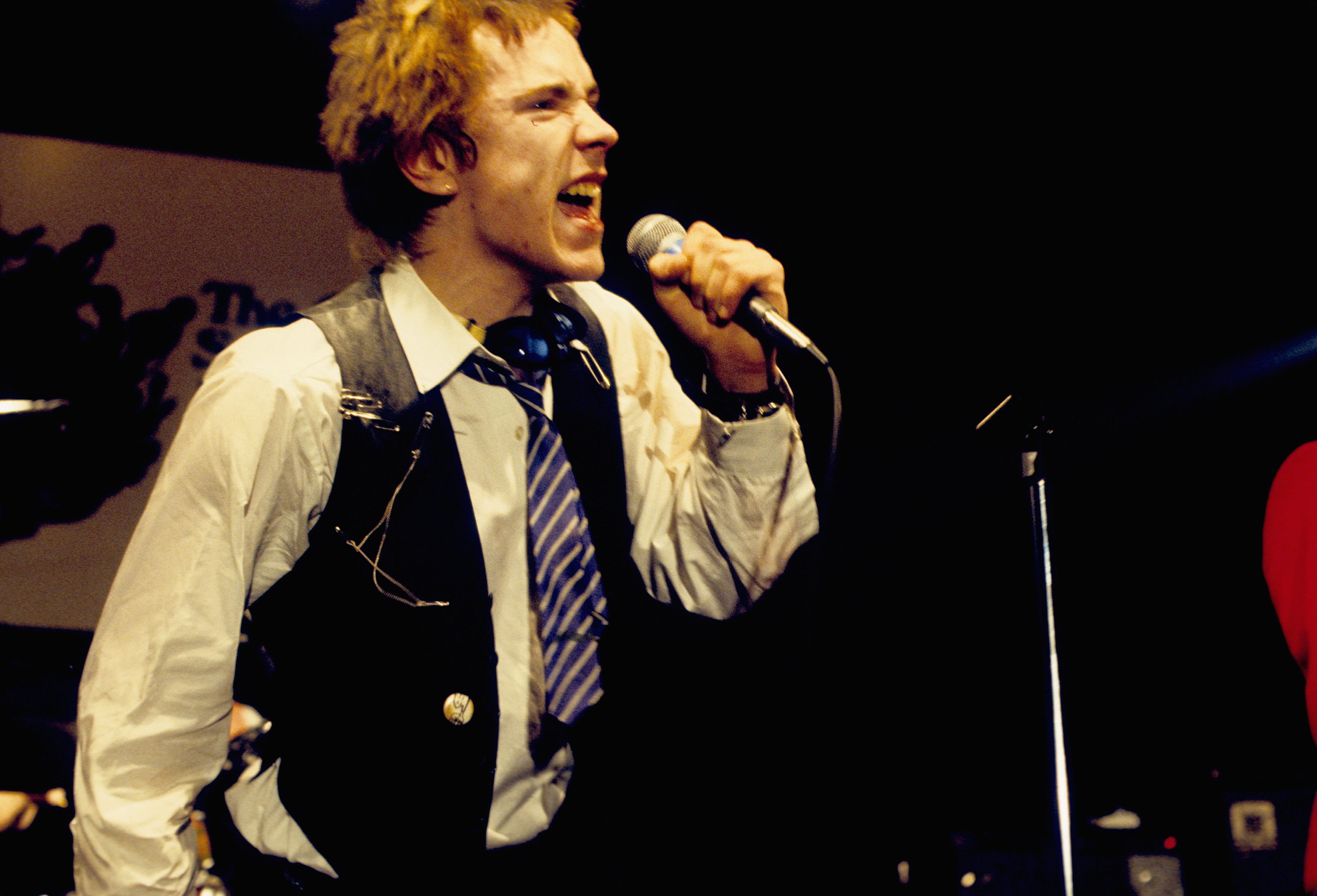 Sex Pistols' Johnny Rotten holding a microphone