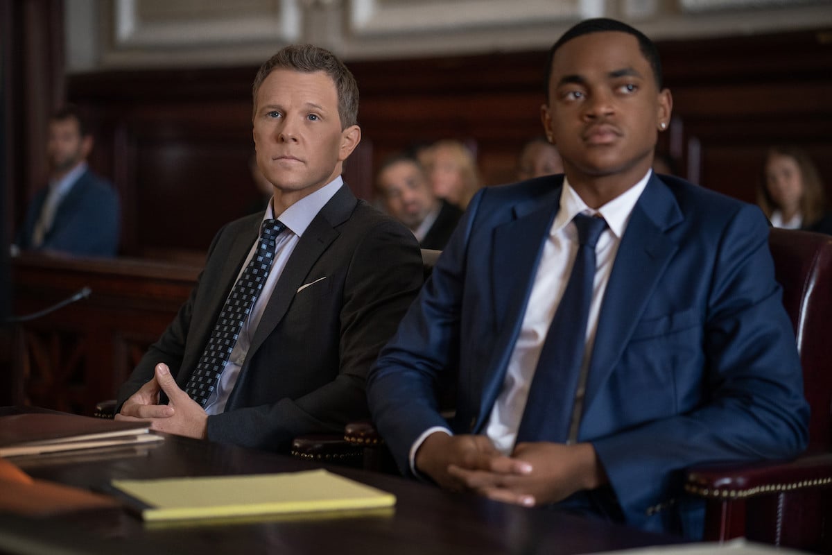 Shane Johnson as Cooper Saxe and Michael Rainey Jr. as Tariq St. Patrick wearing suits and sitting in the courtroom in 'Power Book II: Ghost'