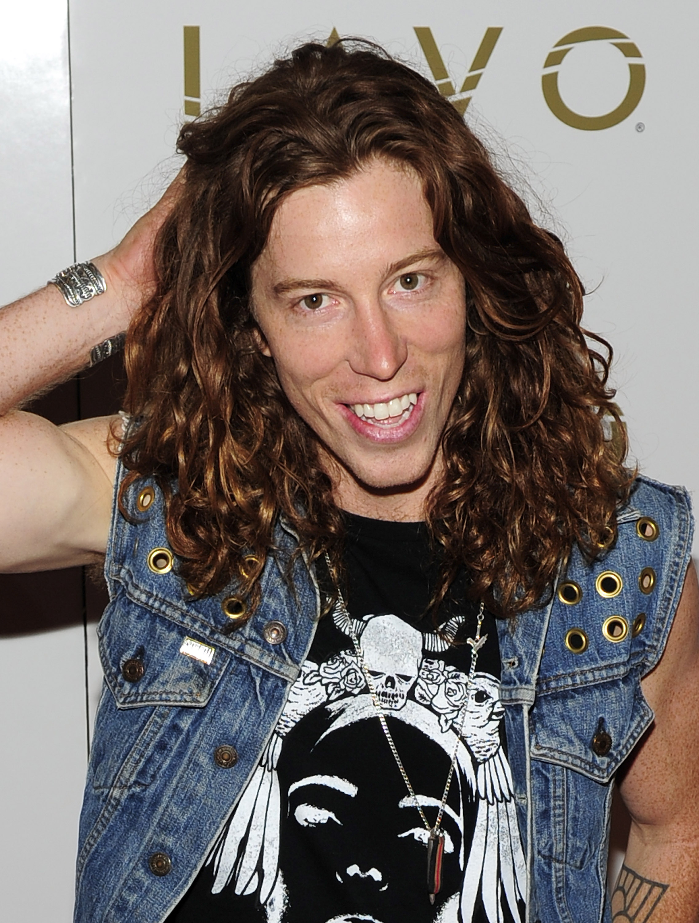 Shaun White running one hand through his long hair during a party at a nightclub in 2010