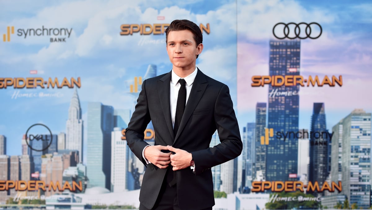 Tom Holland posing in a black suit, white dress shirt, and black tie attends the premiere of Columbia Pictures' "Spider-Man: Homecoming" at TCL Chinese Theatre on June 28, 2017 in Hollywood, California