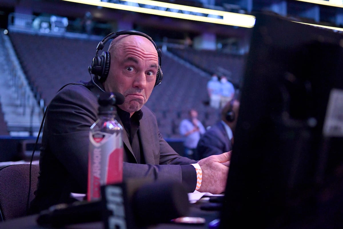 Spotify podcast host Joe Rogan sits behind the video screens while preparing to host UFC 249