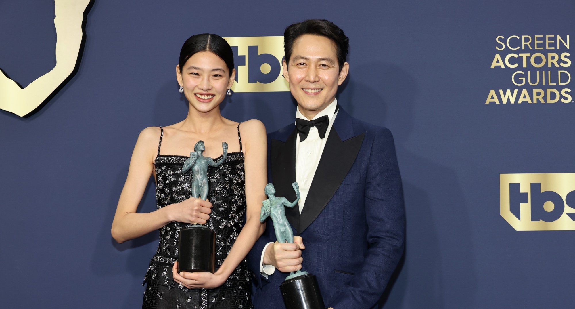 'Squid Game' HoYeon Jung and Lee Jung-jae at the 2022 SAG Awards holding awards.