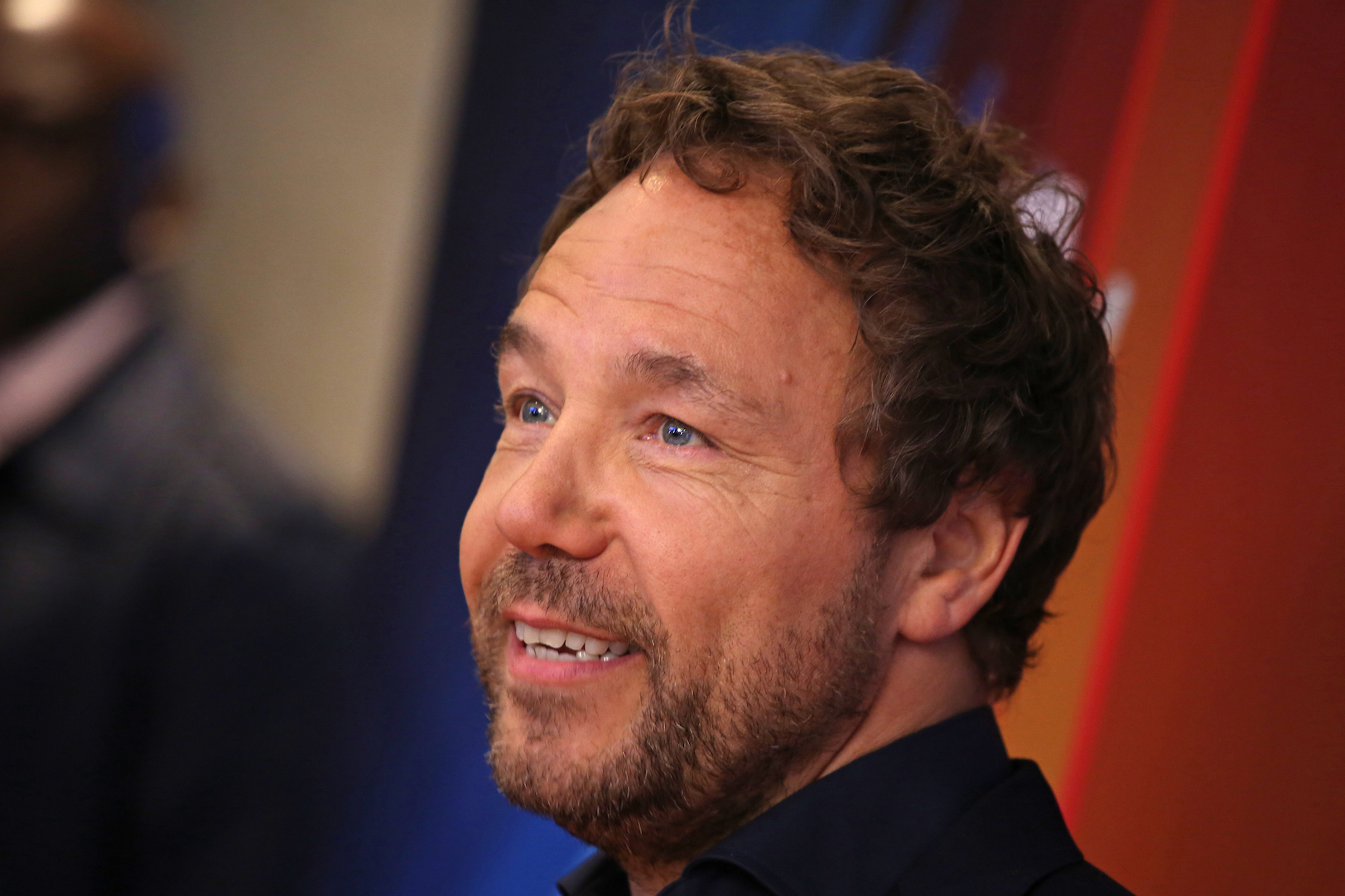 A close-up of 'Peaky Blinders' Season 6 star Stephen Graham smiling at an event