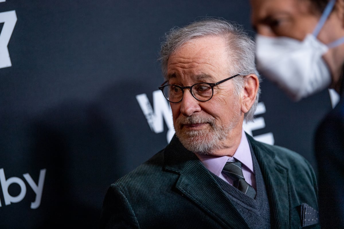 Steven Spielberg looks to his side while wearing a suit on the red carpet