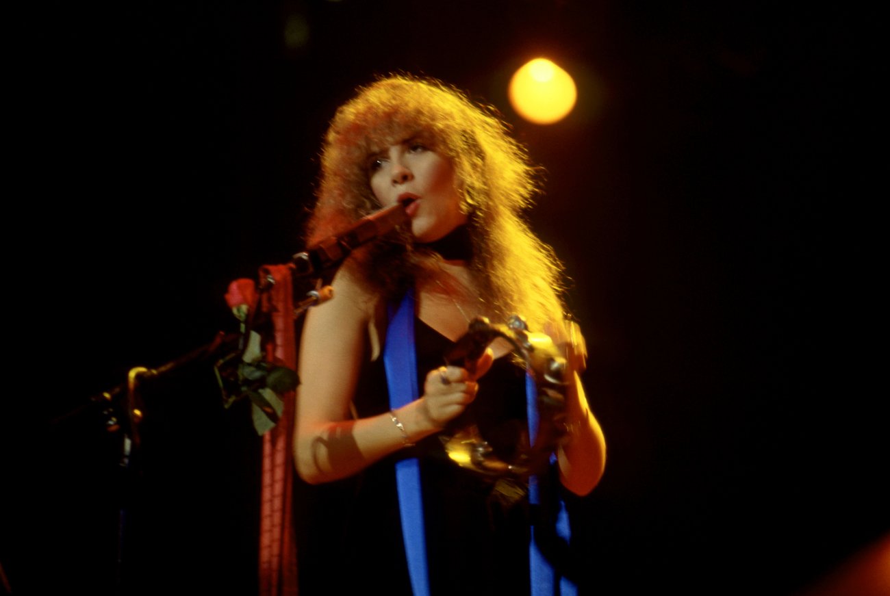 Stevie Nicks wearing black while performing with Fleetwood Mac during the Tusk Tour in 1980.