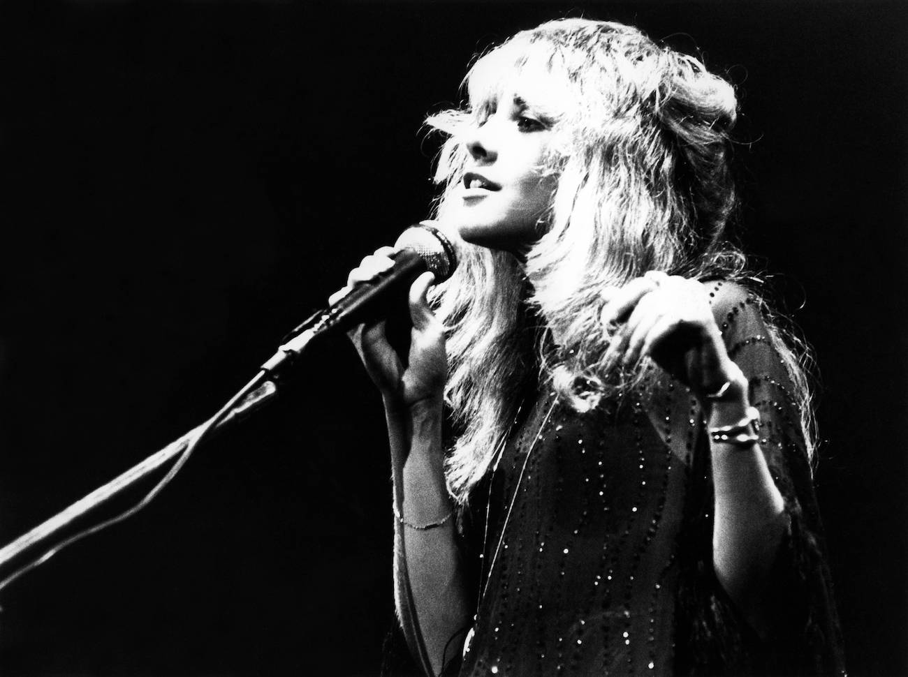 Stevie Nicks in black performing with Fleetwood Mac in 1977.