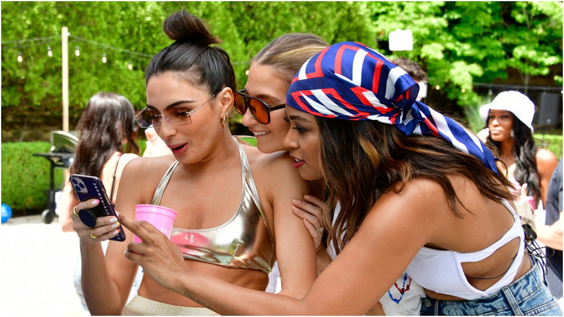 Paige DeSorbo, Amanda Batula, Mya Allen from 'Summer House' look at some hot gossip on a cell phone