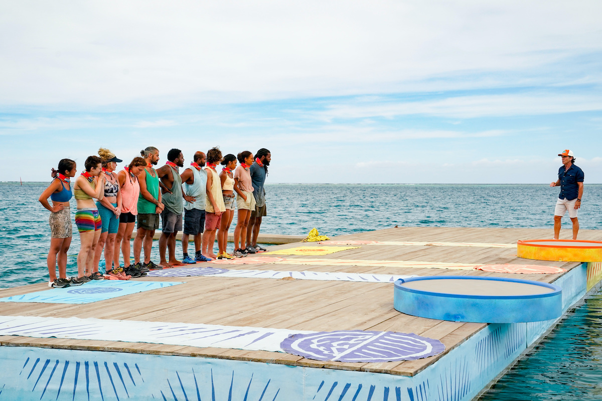 Reality TV competitors on 'Survivor' on a floating dock, waiting to begin competition