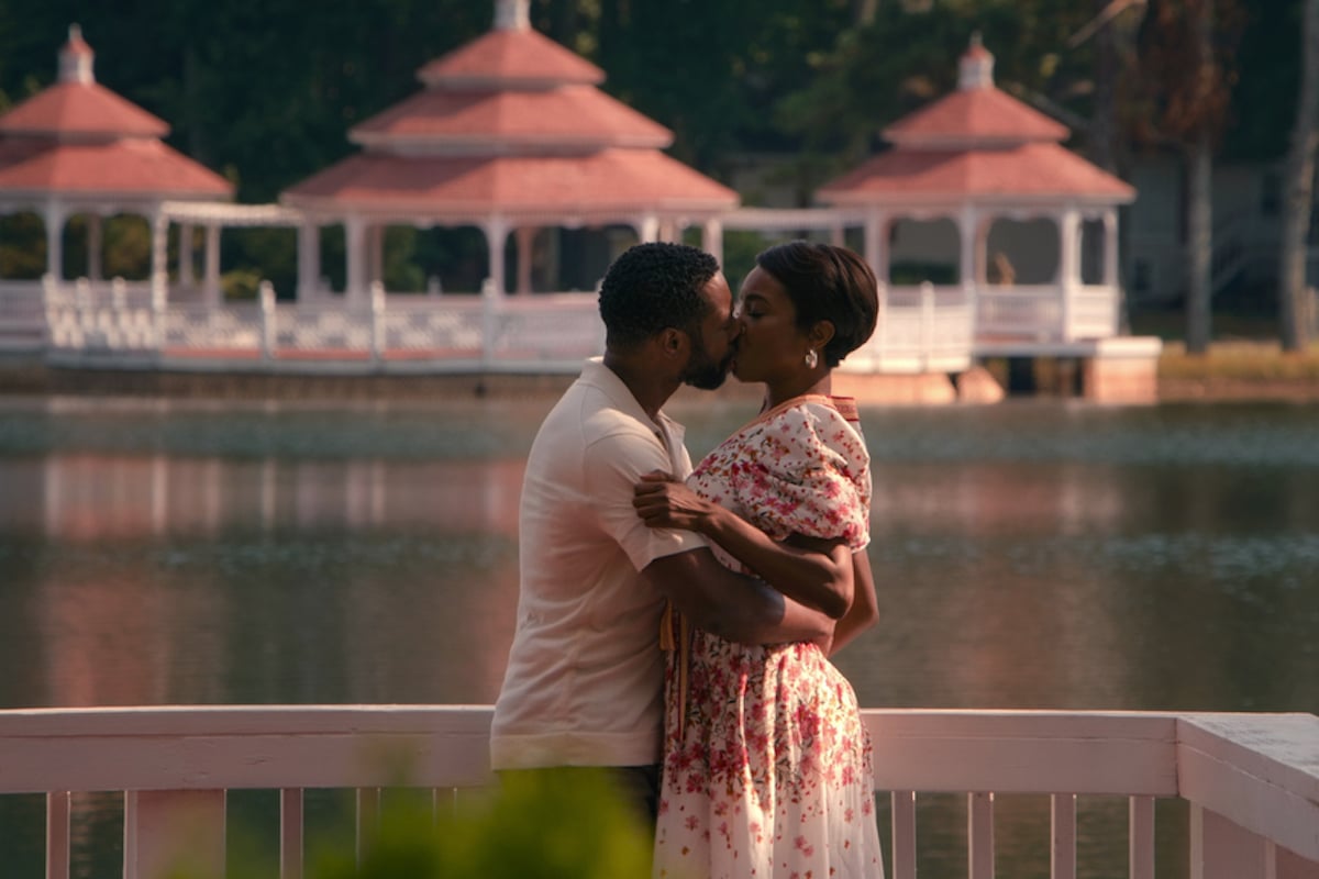 Erik and Helen kissing in front of a lake in 'Sweet Magnolias' Season 2