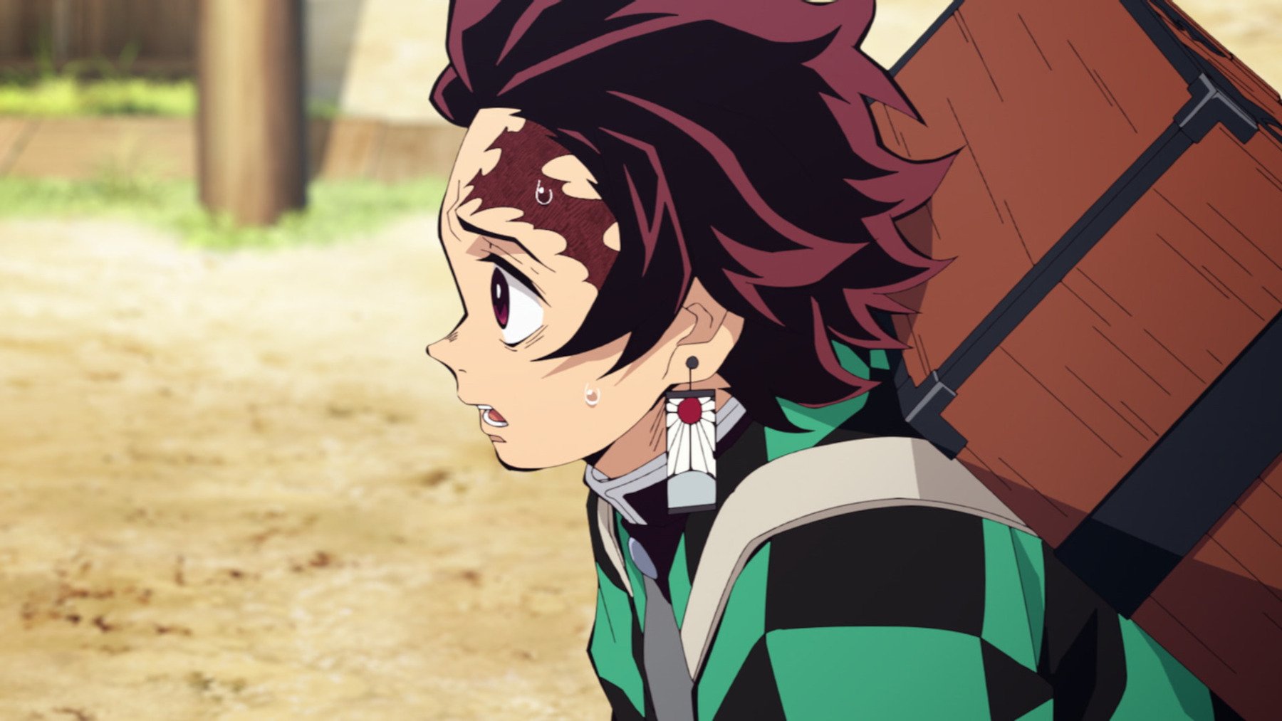 Tanjiro in episode 1 of 'Demon Slayer' Season 2's Entertainment District Arc. The image shows his side profile, and he's looking at something off-screen.
