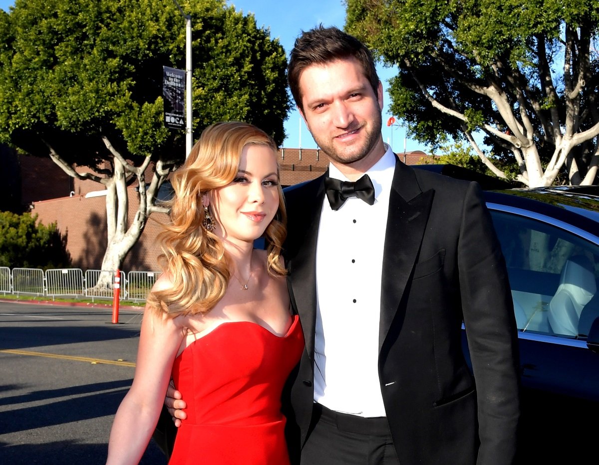 Tara Lipinski wearing a red gown and her husband, Todd Kapostasy, sporting a tuxedo at the Elton John AIDS Foundation Academy Awards Viewing Party