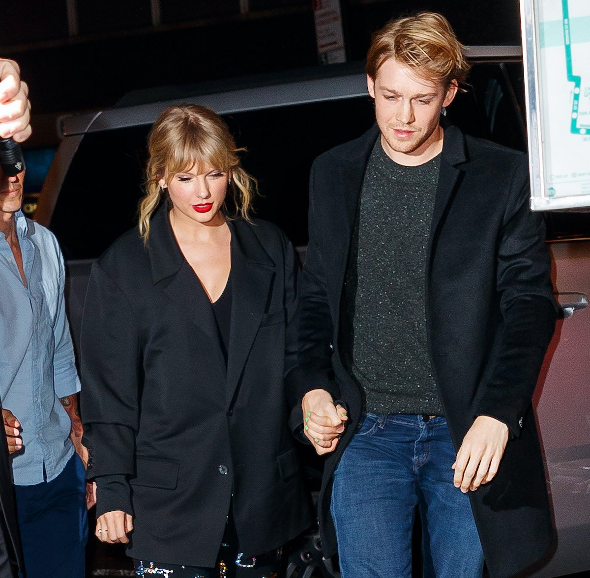 Taylor Swift and boyfriend Joe Alwyn hold hands as they exit a car