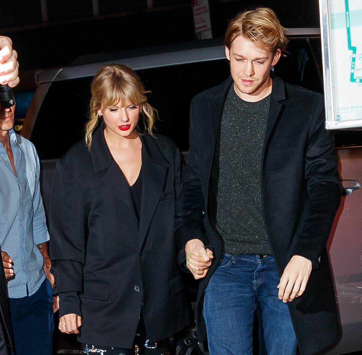 Taylor Swift and her boyfriend, Joe Alwyn, hold hands while leaving a car