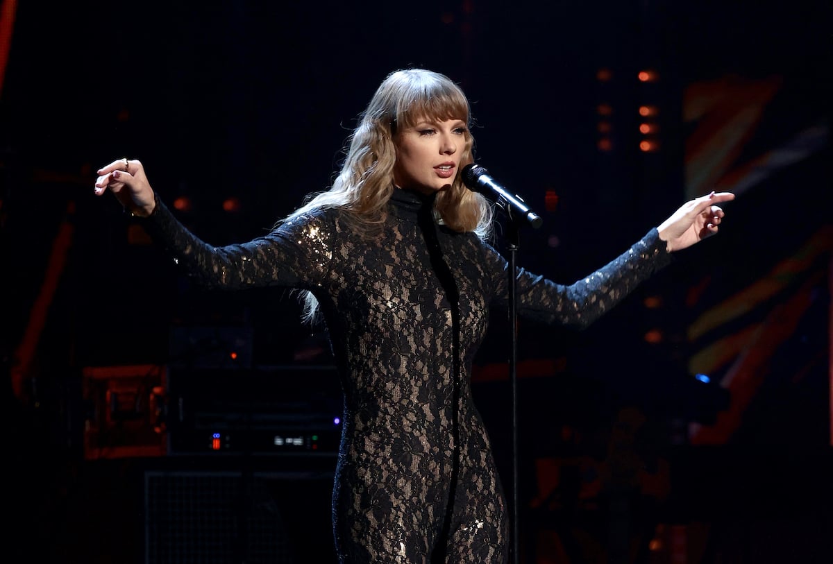 Taylor Swift performs songs in a lacy black jumpsuit