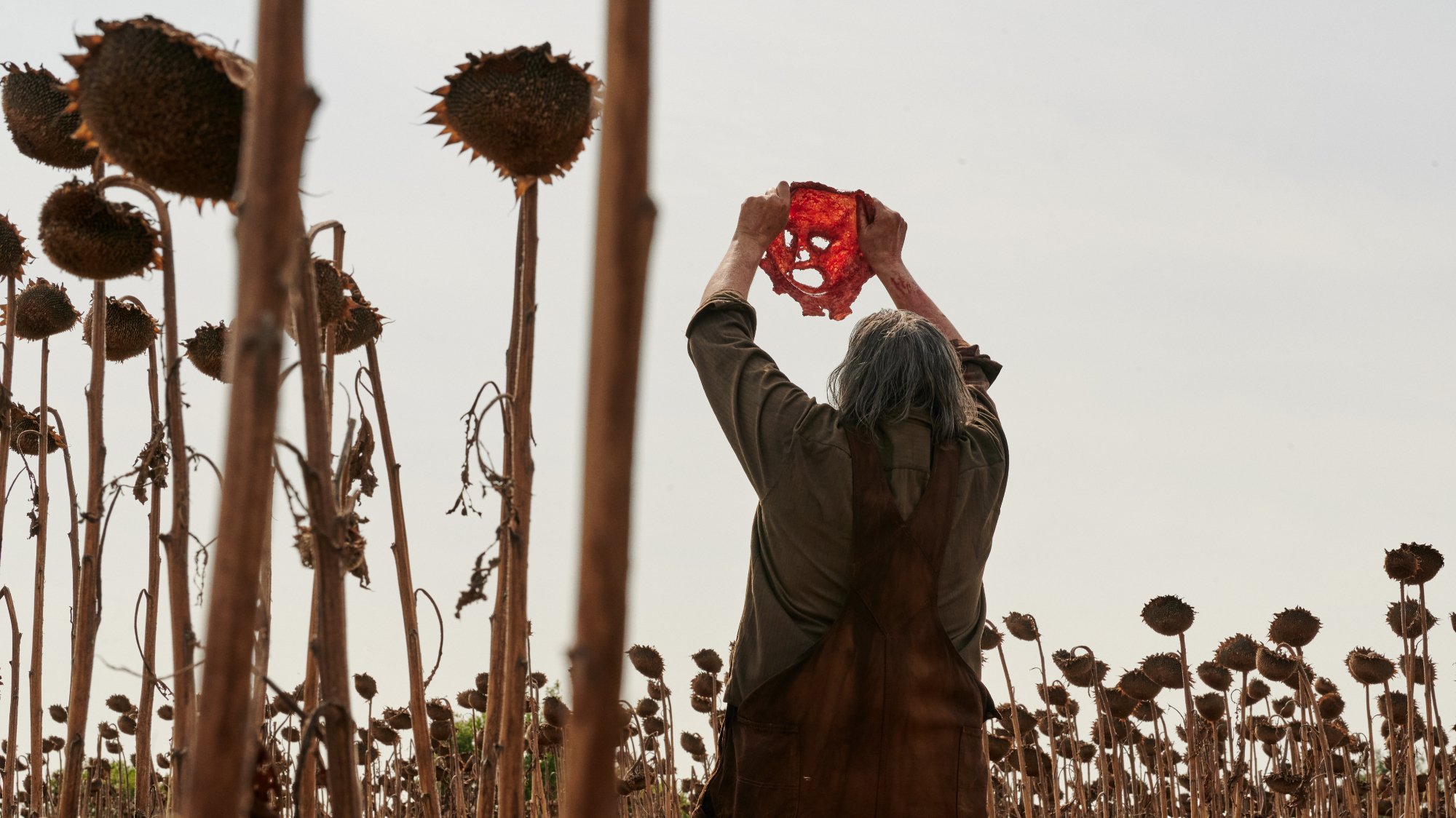 'Texas Chainsaw Massacre' Mark Burnham as Leatherface holding up skin mask